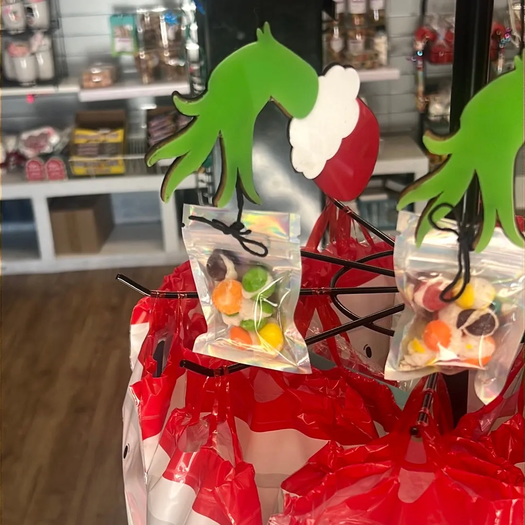 Acrylic, grinch hand, ornament, attached to a bag of freeze dried treats