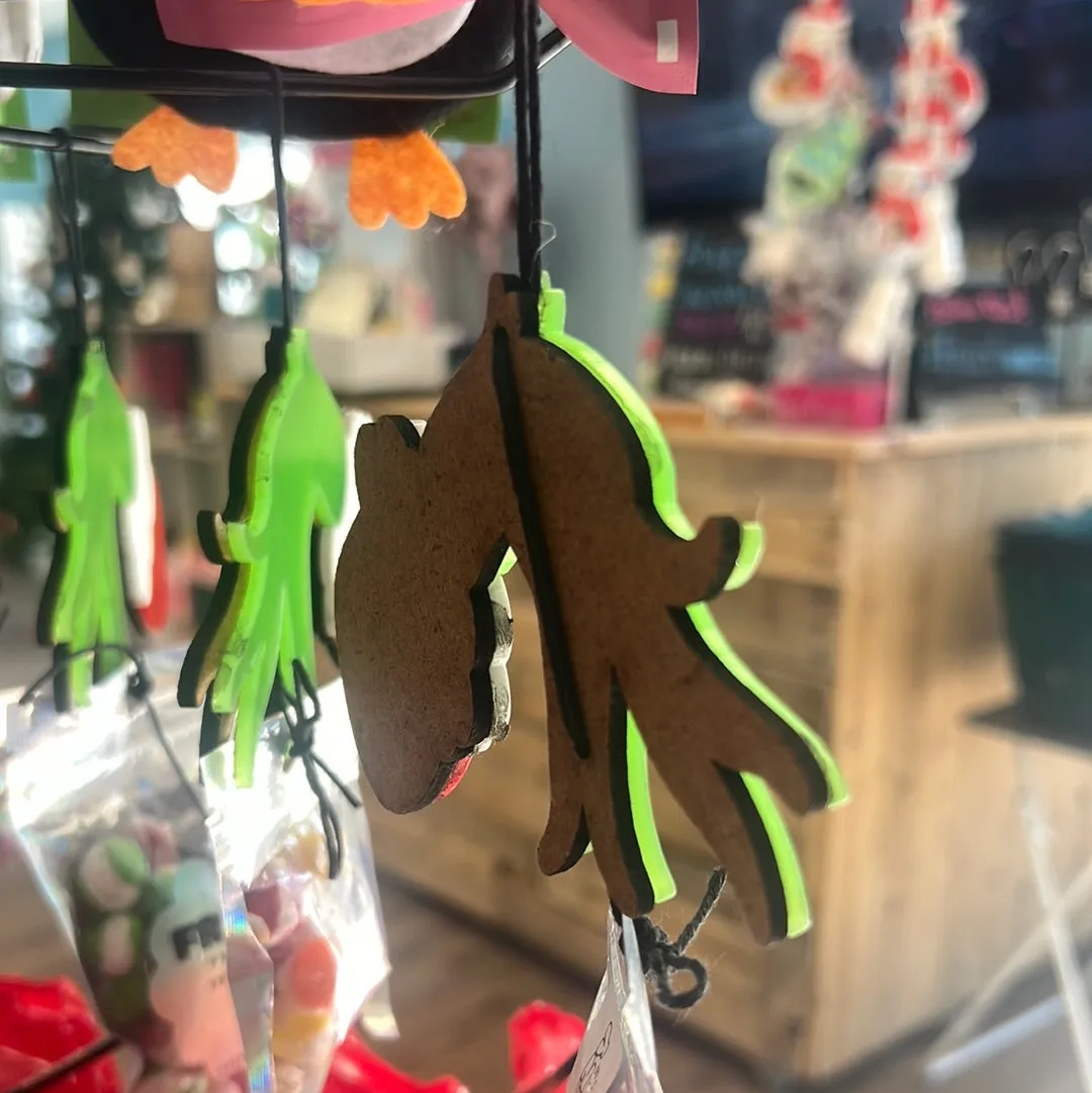 Acrylic, grinch hand, ornament, attached to a bag of freeze dried treats